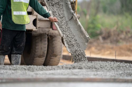 pouring ready mix concrete on a driveway project